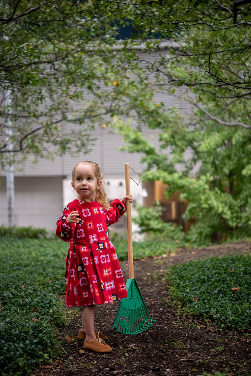 child with toy rake