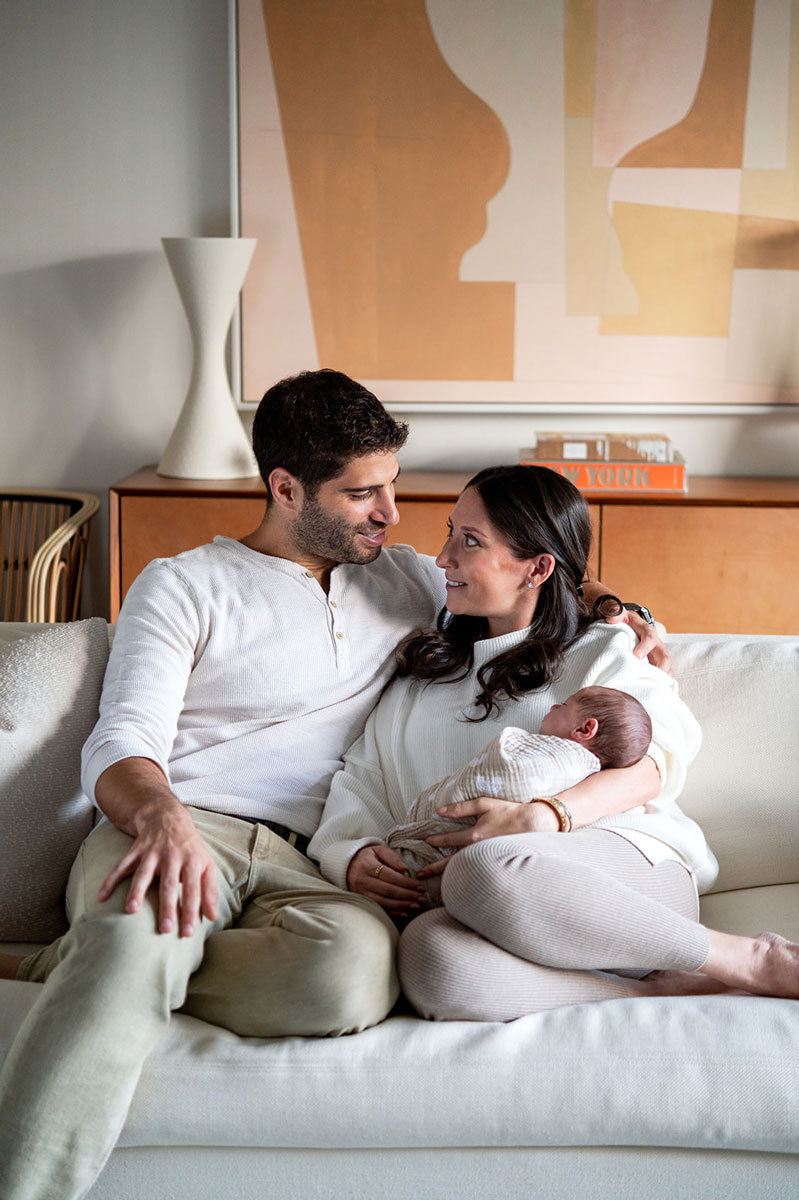 man and woman with newborn