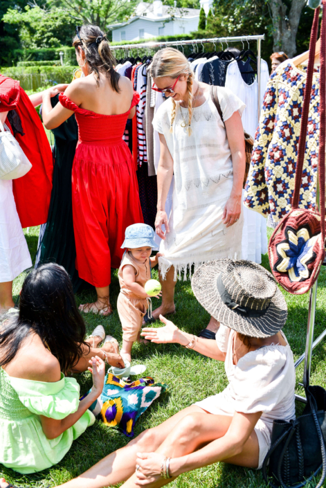 women and children enjoying a shopping event in the gardens at reform in the hamptons
